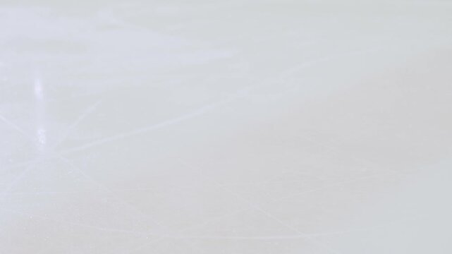 A hockey player deflects the puck on the ice, close-up. 