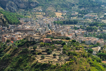 Fototapeta premium Collesano, a historic Sicilian mountain town in the Madonie Mountains, featuring narrow stone streets, traditional houses, and the Church of San Pietro, Sicily, Italy. Italian town in hills