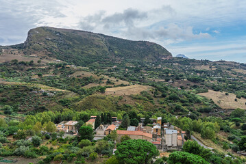 Fototapeta premium Collesano, a historic Sicilian mountain town in the Madonie Mountains, featuring narrow stone streets, traditional houses, and the Church of San Pietro, Sicily, Italy. Italian town in hills