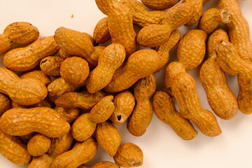 Bunch of peanuts with shell on a white surface