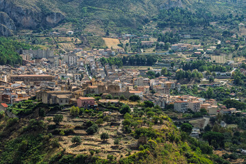 Fototapeta premium Collesano, a historic Sicilian mountain town in the Madonie Mountains, featuring narrow stone streets, traditional houses, and the Church of San Pietro, Sicily, Italy. Italian town in hills