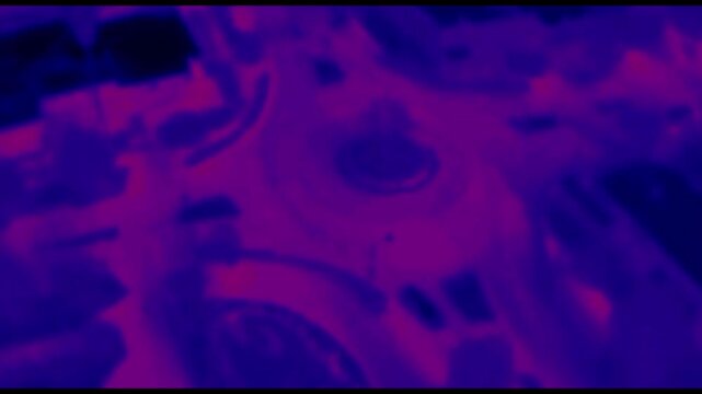 A Traffic Circle with Traffic and Cars on the road showing the heat gradient and radiated energy as the cars go around the circle from an overhead drone