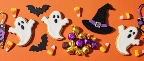 Obraz premium Halloween Flatlay Advertisement Orange Fabric Spooky Cookies Candy Corn Witch Hat Trick or Treat Bags