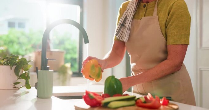 Hands, washing pepper and water at kitchen sink with faucet, vegetables and hygiene at home. Person, cleaning ingredients and rinse organic food for cooking, meal preparation and flare at apartment