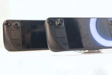Two portable game consoles on a white background — a studio photo of modern gaming devices...