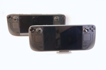 Two portable game consoles on a white background — a studio photo of modern gaming devices showcasing ergonomics, design, and functionality for technical reviews.