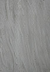 Fototapeta premium Rough, weathered gray surface with subtle variations and granular details. Ideal for backgrounds, overlays, or abstract designs ,design ,detail ,stone