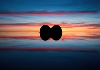 Serene heart shape reflecting perfectly on calm water surface. Symbolizes deep emotional introspection, self-love, and peaceful contemplative thought ,harmony ,calm ,mirror