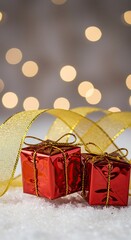 A festive red and gold Christmas gift box, tied with a shiny ribbon, resting on a soft, snowy background ,packaging ,greeting ,gold
