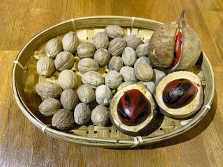 Nutmeg Fruits and Seeds in Traditional Bamboo Basket
