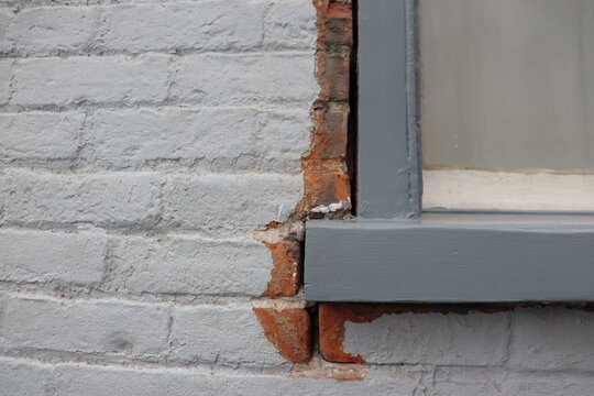 Old outdoor wall and repair window and bricks. Poorly insulated exterior wall and window repair. Old window and construction for repair.