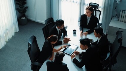 Top view of diverse business team discuss about marketing idea while businessman analyze financial graph from tablet at meeting room. Group of smart team brainstorm idea at conference. Directorate. - Powered by Adobe