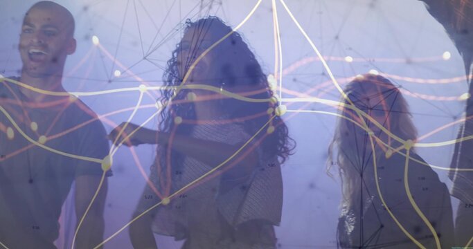 Exploring team of four collaborating under digital network projection in dim gallery, haze