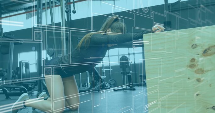 Kneeling woman stretching torso forward on padded mat in gym wearing dark top, using plyometric box - Powered by Adobe
