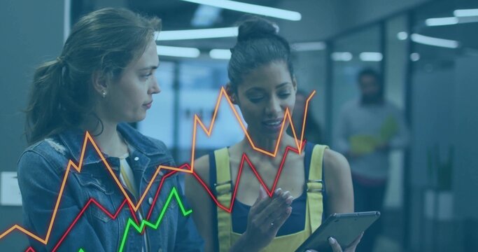 Two coworkers wearing yellow overalls studying tablet in office corridor, with chart overlay - Powered by Adobe
