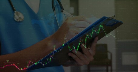 Writing on clipboard clinician wearing scrubs and stethoscope in clinic with digital graph overlay