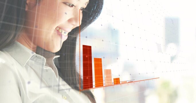Analyzing Asian professional examining orange and red bar chart grid overlay at office, copy space - Powered by Adobe