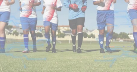 Five female soccer players starting warmup by jogging toward camera, zooming down to shin guards - Powered by Adobe