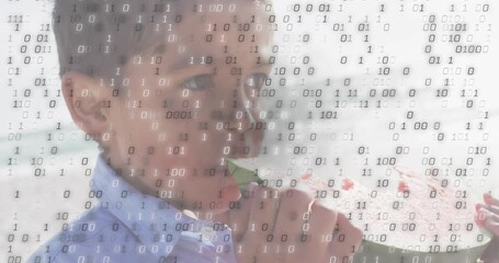 Boy lifting watermelon slice and biting as drifting binary code overlay shows technology theme - Powered by Adobe