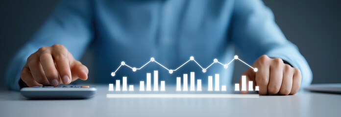 Businessman touches holographic display showing ascending financial performance graphs.

