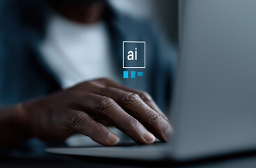 Professional works on laptop with artificial intelligence icon prominently illuminated.

