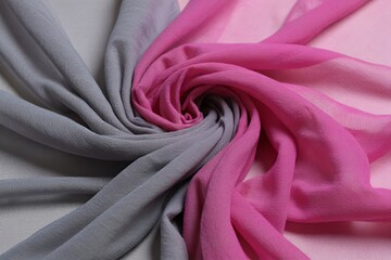 Obraz premium Abstract textile composition swirled pink and gray fabric on neutral backdrop