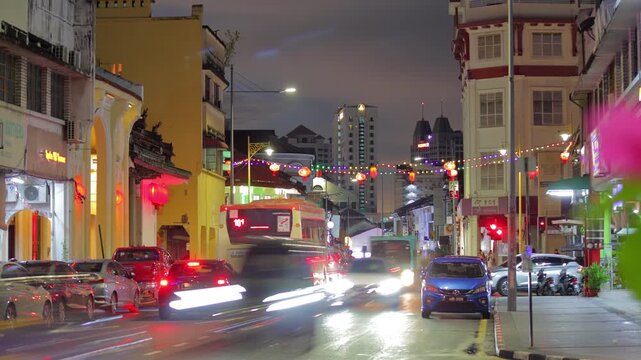 sunset twilight time illumination george town old city center traffic crowded street panorama 4k timelapse penang malaysia 