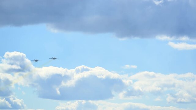 Slow motion view of the approaching formation of two F 18 fighter jets at bright sky, showcasing military strength, speed, and precision.