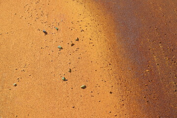 Rusty metal background in brown, red and orange colors. Rusty métal with particles and texture. Grainy rust and construction industry. Canvas and pattern in metallic texture.	