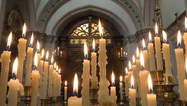Multitude of Illuminated Tapered Candles Exhibiting Dripping Molten Tallow Soft Radiant Glow from the Flames Generates an Ambiance of Comfort Serenity and Quietude a Concept for a Day of Remembrance