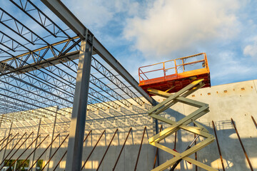 Assembling of metal and concrete frame building at industrial construction site. Commercial real...