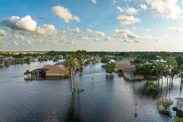 Fototapeta premium Flooding in Florida caused by tropical storm from hurricane Debby. Suburb houses in Laurel Meadows residential community surrounded by flood waters in Sarasota. Aftermath of natural disaster
