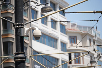 Security camera in urban setting with buildings nearby