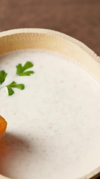 Vertical Video, Brukina, Degue, West Africa Africa Ghana Traditional drink, sweet, beverage made from millet milk and thick