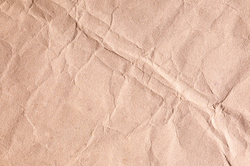 Brown crumpled paper texture with diagonal creases lines