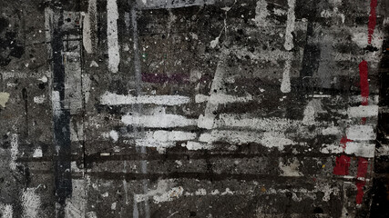 Urban textured surface street or wall heavily layered with dirty, abstract paint splatters and streaks. Dark gray background with muticolored lines © sutthichai