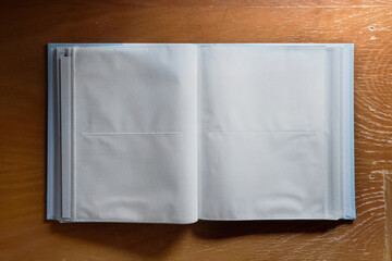 old open photo album on rustic wood background, mock up vintage photography album 