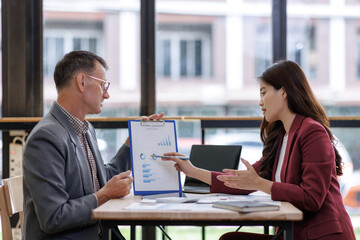 Business professionals discussing financial data during meeting
