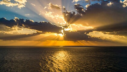 A dramatic sunrise over the ocean, with golden light beams
