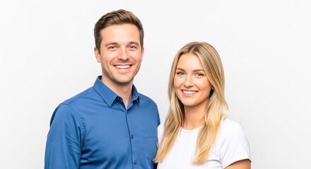 Fototapeta premium A smiling couple standing against a white background.