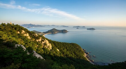 Fototapeta premium Coastal Serenity - Lush Green Hills and Tranquil Blue Waters.