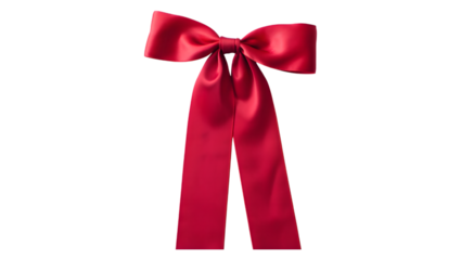 Elegant red satin bow tied with long flowing tails isolated on a solid black background