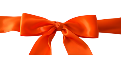 Vibrant orange satin ribbon tied into a classic bow against a stark black background for festive decoration
