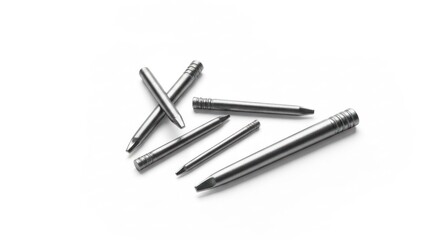 Close-up of several metal, cylindrical pins with pointed and ridged ends, scattered on white