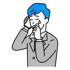 スマートフォンでの通話で泣くスーツの男性
