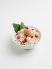 Nasi Liwet Sunda or steamed rice with seasoning and fried anchovy on white background