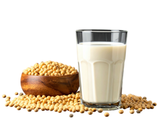 Clear glass of creamy liquid next to a wooden bowl of golden beans