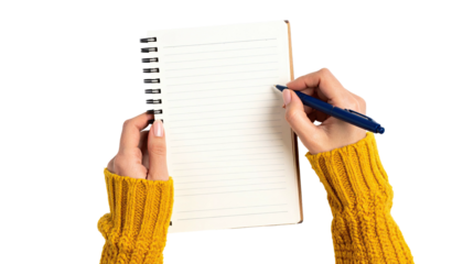 Close-up of hands holding notebook with pen, writing on blank lined paper