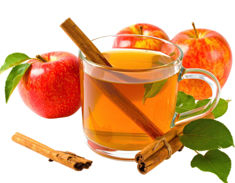 A transparent mug of apple tea with cinnamon sticks and fresh red apples