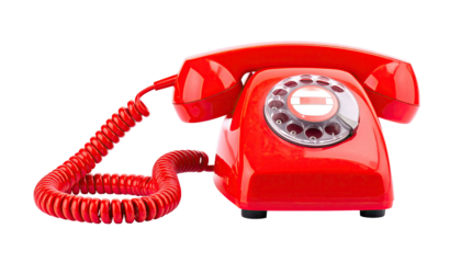 A vibrant red rotary telephone sits isolated against a stark black background